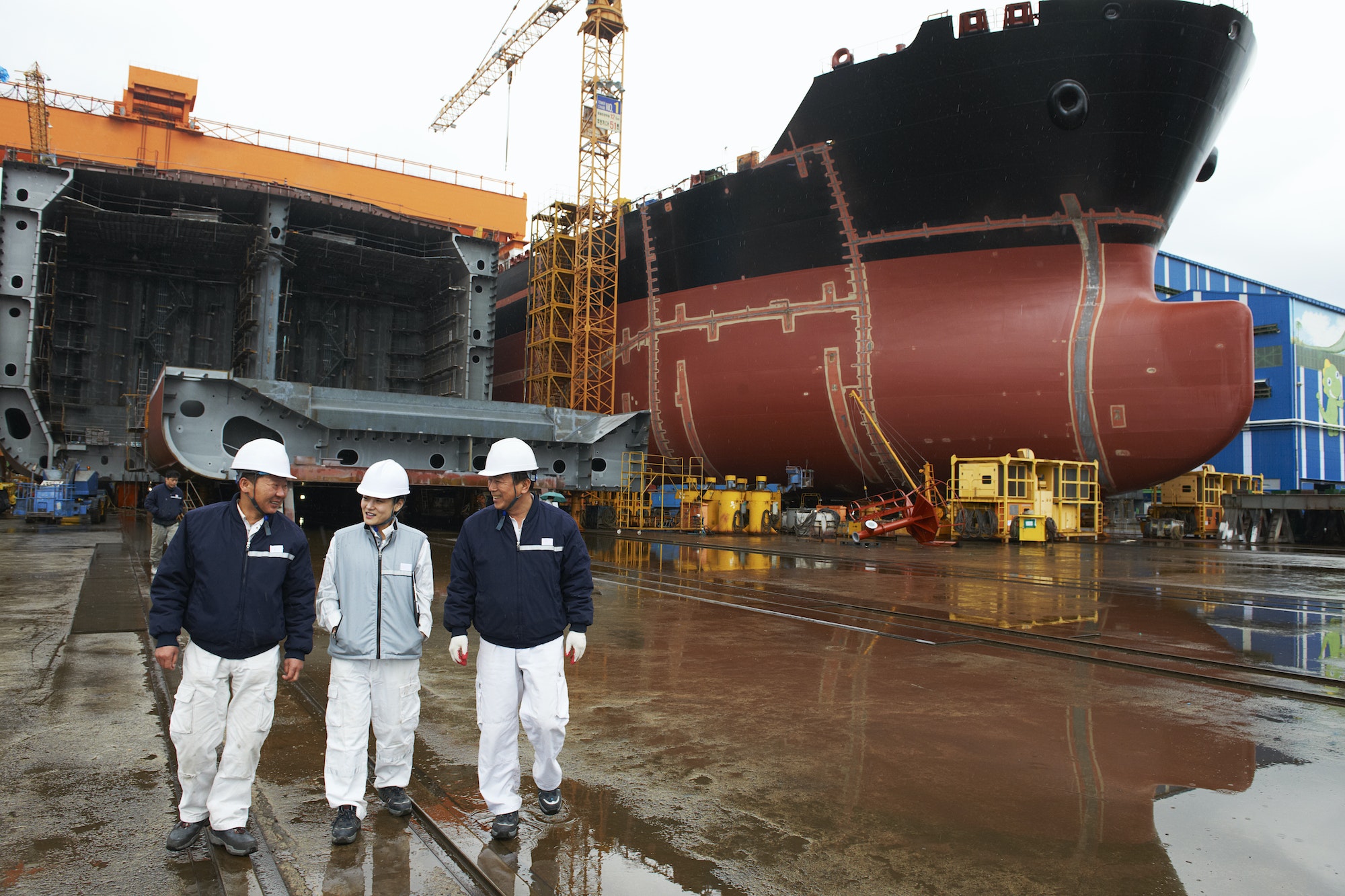 Workers walking through shipyard, GoSeong-gun, South Korea